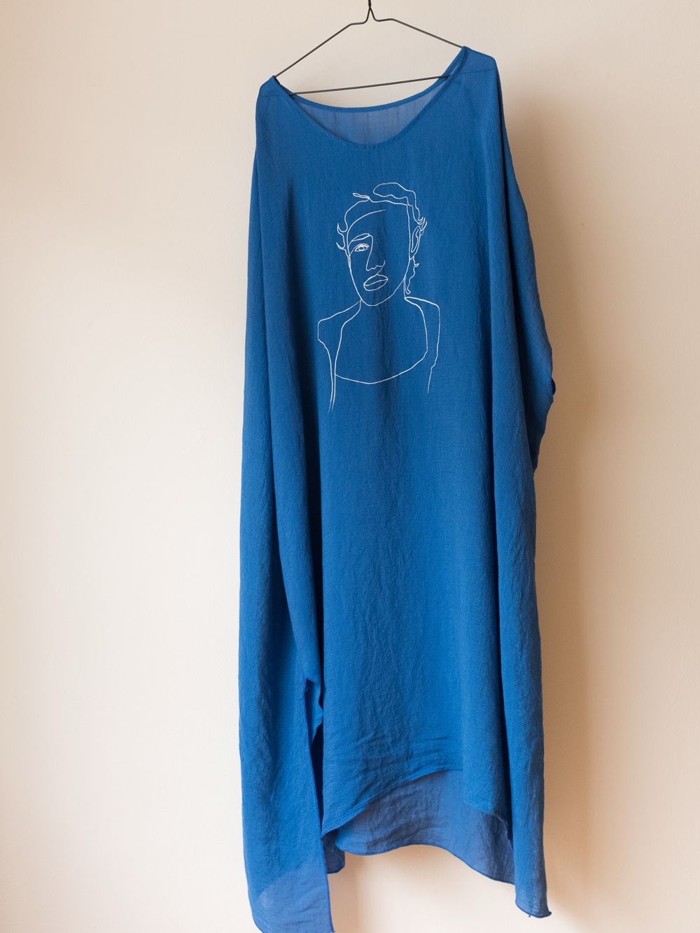 Blue Flowing Tunic with Minimalist Face Line Art